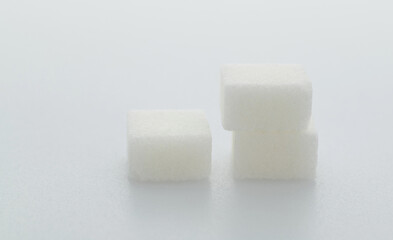 Three sugar cubes on white background