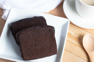 Chocolate cake with coffee in a white plate