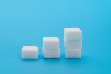 Sugar cubes chart on blue background