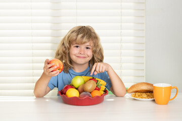 Kid eating apple. Healthy nutrition for children. Cute boy enjoy eating for morning breakfast with appetite. Hungry child eat tasty fruits and vegetables.