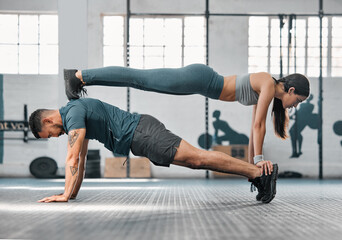 Strength, active and fit couple exercising, training or doing workout exercise routine inside gym...