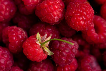 Background of macro berries of ripe and juicy raspberries