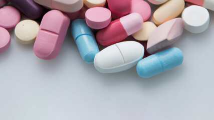 Obraz na płótnie Canvas Different colored pills background, close up