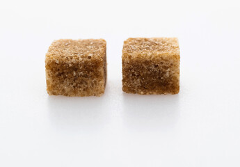 Brown sugar cubes on white background