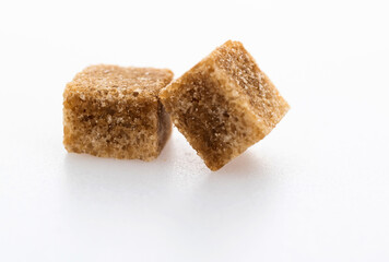 Brown sugar cubes on white background