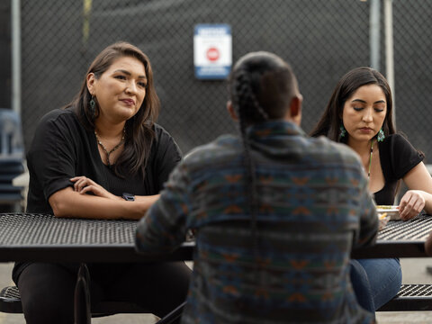 Native teacher looking at one of her students at a lunch table