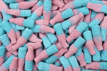Tasty candies in bottle shape in pink and blue colors. Top view.