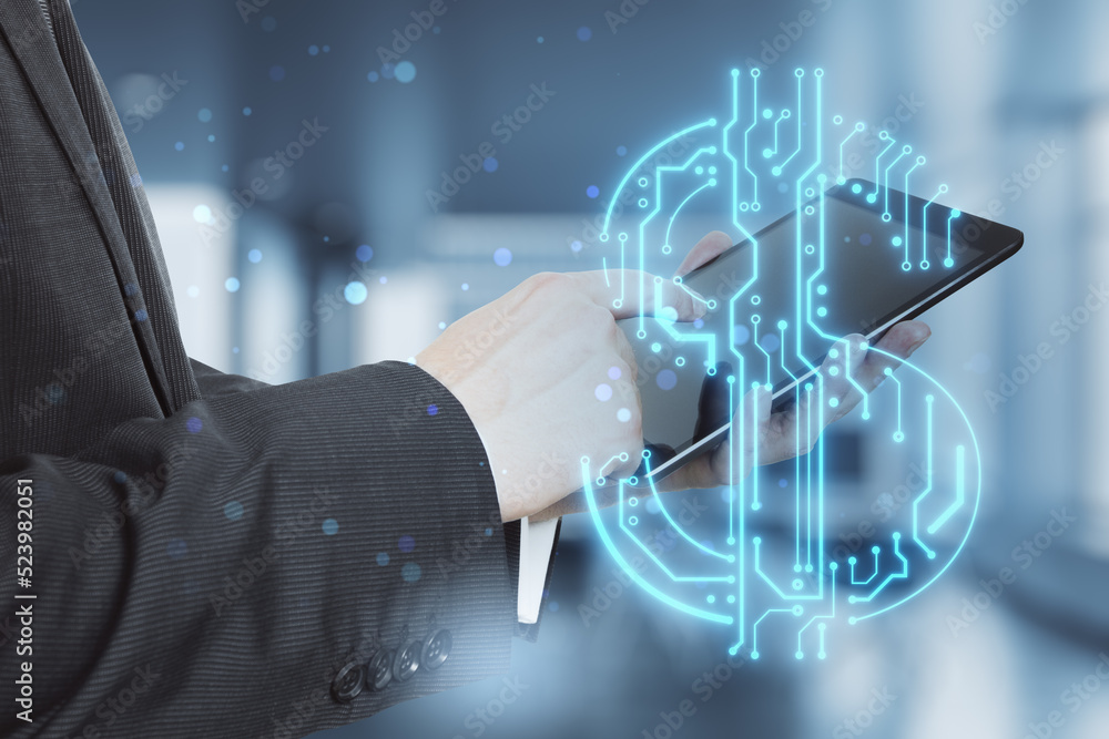 Poster man hands holding and pointing at tablet with abstract glowing blue circuit dollar hologram on blurry bokeh office interior background. Online banking and financial technology concept. 