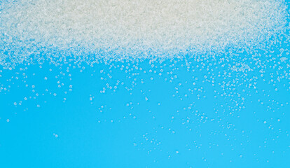 White sugar crystals on blue background