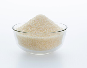 Granulated sugar in a bowl on white background