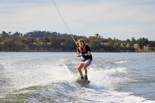 kid wakeboarding on fresh water lake