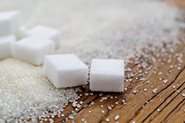 Fototapeta na wymiar Sugar cubes on top of granulated sugar