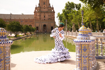 Flamenco dancer woman, beautiful brunette teenager dressed in typical costume with ruffles and...