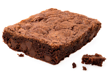 Chocolate brownie with chocolate chips next to crumbs isolated on white.