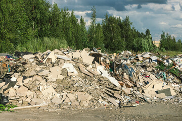 Unauthorized garbage dump in the city. Environmental pollution. Construction debris pollutes city streets.