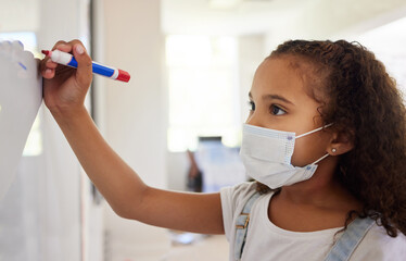 School student writing on whiteboard in class during covid pandemic for learning, education and study. Young kindergarten, preschool or elementary kid with mask for safety, protection and protocol