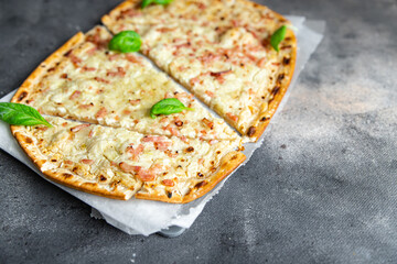Flammkuchen savory pie bacon, onion, sour cream pastrie meal food snack on the table copy space...