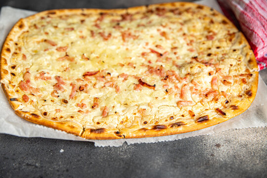 Flammkuchen savory pie bacon, onion, sour cream pastrie meal food snack on the table copy space food background