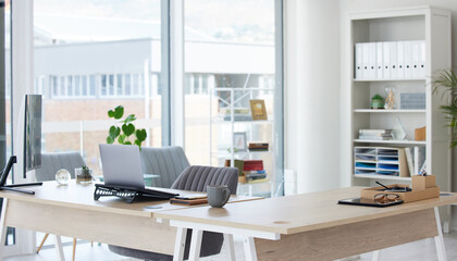 Clean, bright and empty home office interior organized with a computer and desk inside. Modern, contemporary and work space view of a decorated room with stylish decor and wooden furniture indoors - Powered by Adobe