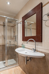 Interior of a new luxury bathroom with a mirror in a leather frame.