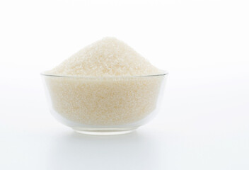 Granulated sugar in a bowl on white background