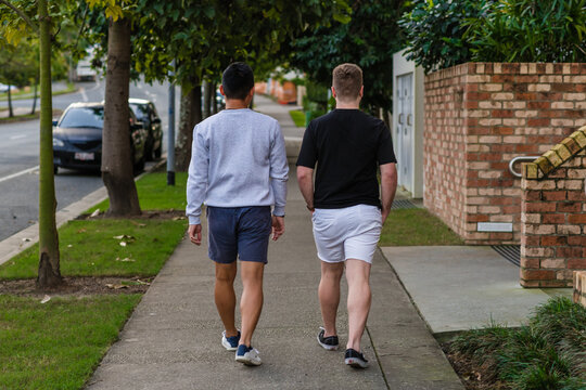 two men walking on the footpath