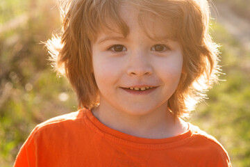 Kids emotions. Happy smiling boy outdoor. Childhood concept.