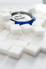 Cola can in pile of sugar cubes
