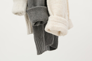 Hanging sweaters, concept of autumn season clothes