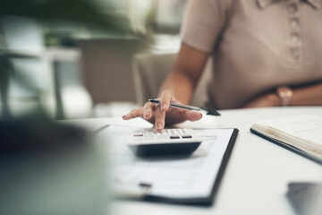 Accountant, finance and business woman calculating a budget or expense in her office. Closeup of a financial advisor planning tax payment, savings or investment for a company using a calculator