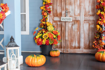 Cozy wooden porch of house with pumpkin in fall. Halloween composition design home with yellow fall...