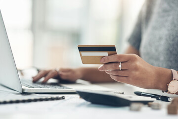 Banking, payment and paying bills online with ebanking on a laptop with a credit or debit card. Closeup of a woman doing online shopping during inflation. Female making payment for debt and mortgage.