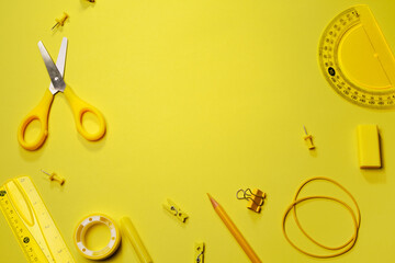 School supplies, office supplies on yellow background, items are also yellow monochrome. Flat lay, top view