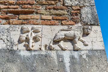 Relief with a lion and tree on the wall of the Saint Nicholas Monastery in Mesopotam, Albania - 523991447