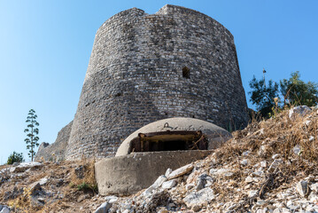 Lekuresi castle and a military concrete bunker in the foreground at Saranda, Albania - 523991451