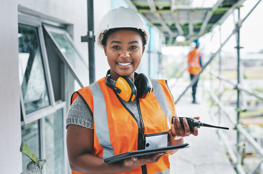 Portrait Of Proud Black Construction Worker Leading With Power While Managing Site Logistics On Tablet. Happy Female Engineer Supervising A Building Project And Inspection Of Architectural Details