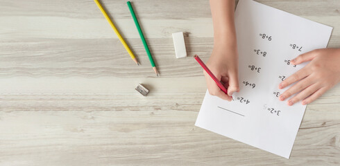 A child solving problems. Arithmetic, addition, calculation, homework, elementary school,...