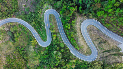 Aerial view road in mountain at thailand. Texture of forest and road view from above.