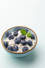 Cottage cheese with blueberry, fresh berries, keto healthy breakfast concept, top view.