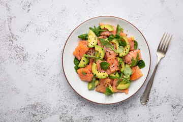 Salmon salad with avocado,  for keto and low carb diet. Rusty background, top view, copy space.