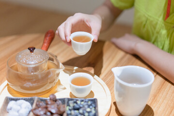Young Asian women brew health tea in moxibustion health museum