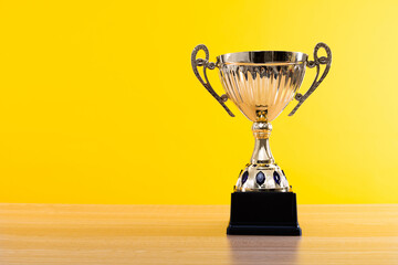 Golden trophy on wooden table