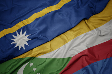 waving colorful flag of comoros and national flag of Nauru .