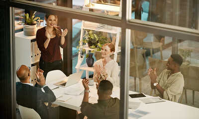 Successful team clapping hands, cheering during deal or meeting in modern office. Diverse group...