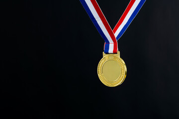 Blank gold medal on black background