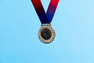 Blank silver medal on blue background
