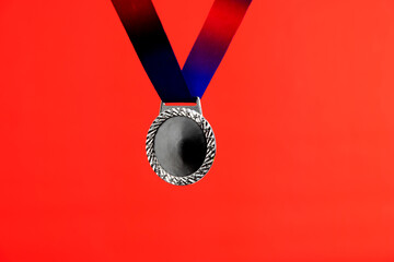 Blank silver medal on red background