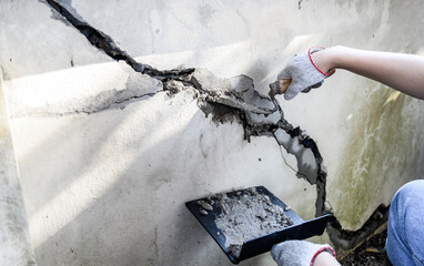 Worker repair and fix cement fence at home. DIY construction and renovate house.