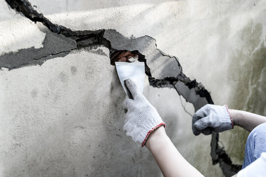 Worker repair and fix cement fence at home. DIY construction and renovate house.