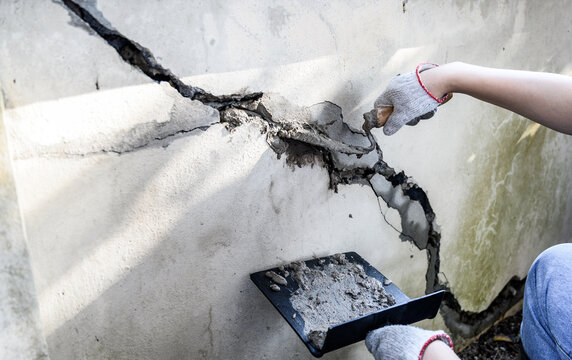 Worker repair and fix cement fence at home. DIY construction and renovate house.